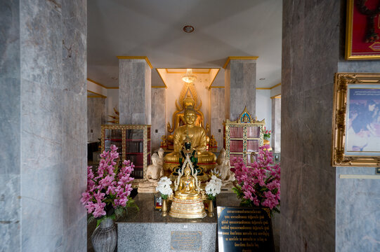 Nakhon Sawan, Thailand, November 11, 2023, Wat Khiriwong - Buddha shrine with flowers at Wat Khiriwong