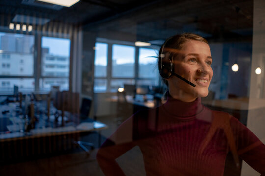 Smiling customer care representative wearing headset in office