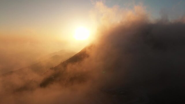 Aerial view above the sea of ​​clouds with the sunset