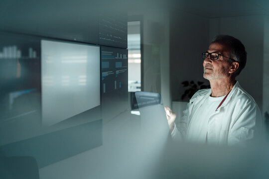 Doctor analyzing medical data on futuristic screen