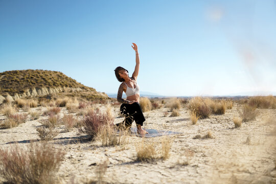 Woman stretching during yoga in the Spanish desert