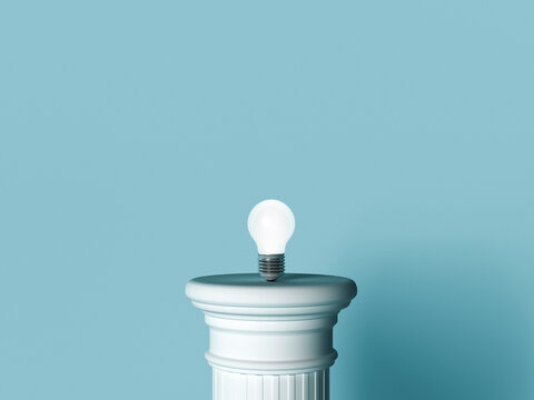 Glowing light bulb on a pillar representing inspiration