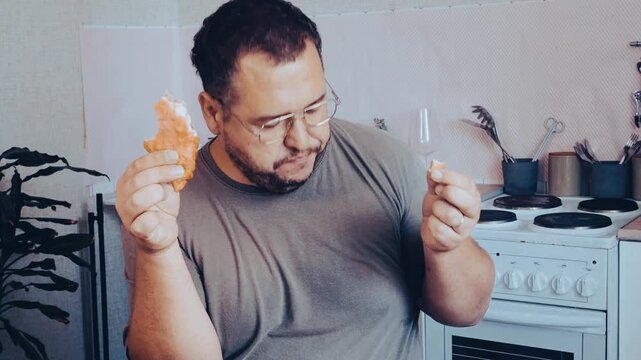 A man eats a triangular pie, samsa or echpochmak in a cafe