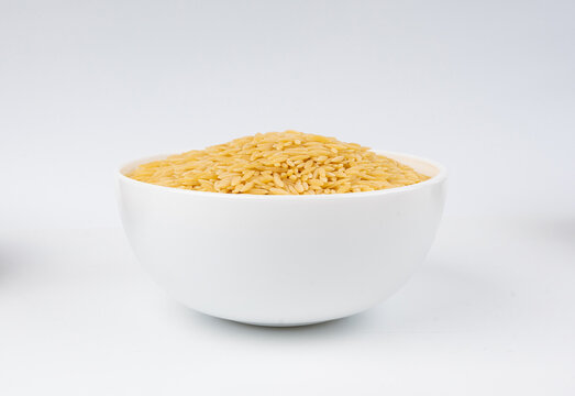 Raw orzo pasta, risoni or kritharaki pile