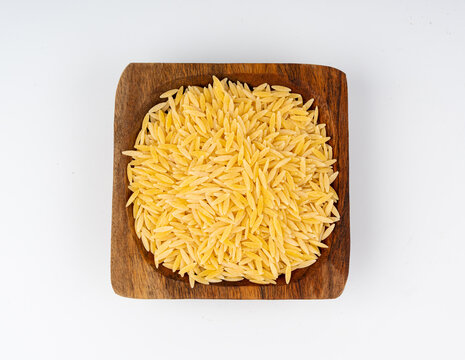 Raw orzo pasta, risoni or kritharaki pile