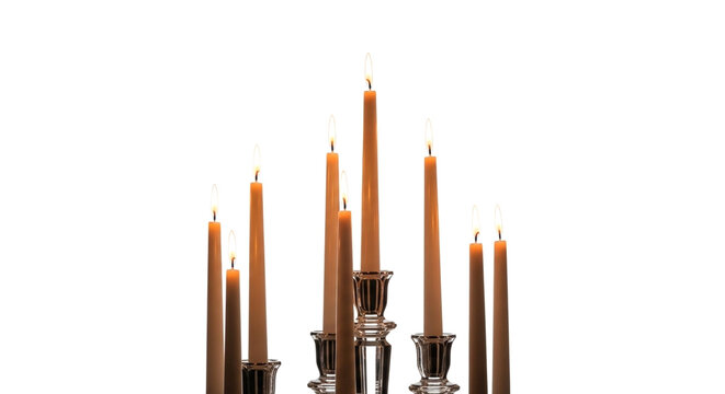 A group of lit taper candles in crystal holders isolated on white background
