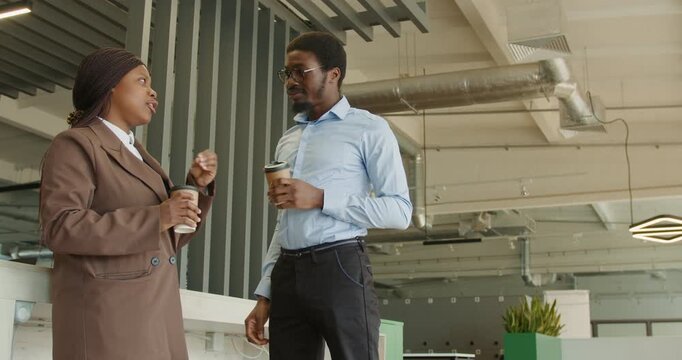 Relaxed and cheerful exchange between coworkers in business setting