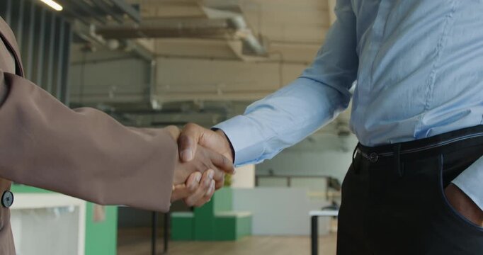 Friendly staff member provides access card to fresh employee in lobby