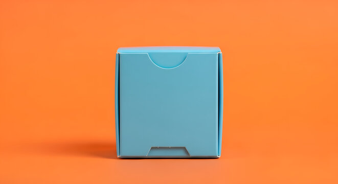 Simple light blue small box on an orange background, studio shot, clean product presentation