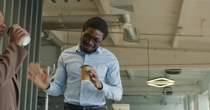 Person smiling and joking during coffee break at work place