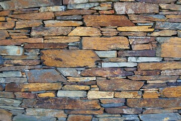 Rough textured stone wall creating natural background © insideportugal