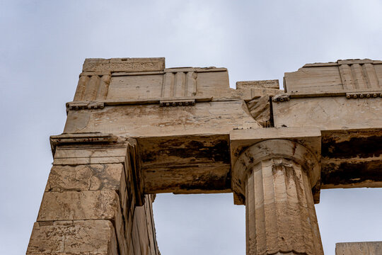 Close-up of the Propylaea ancient gateway showing Doric columns and entablature with triglyphs. Historic Greek ruins at the Acropolis, Athens.