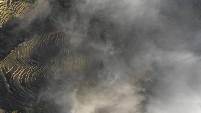 China rural landscapes - drone flight through mist and fog over amazing rice terrace fields in Yuanyang county