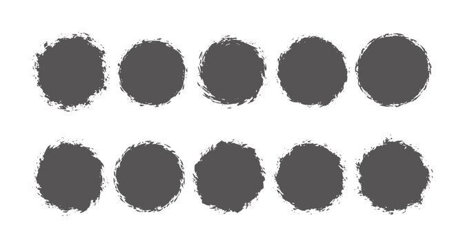 Ten dark grey textured circles arranged in two rows a white grunge abstract