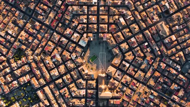 Perfect top-down aerial drone shot revealing the unique hexagonal urban grid of Grammichele, Sicily. Six radial streets converge toward the central Baroque square, creating a stunning geometric patter