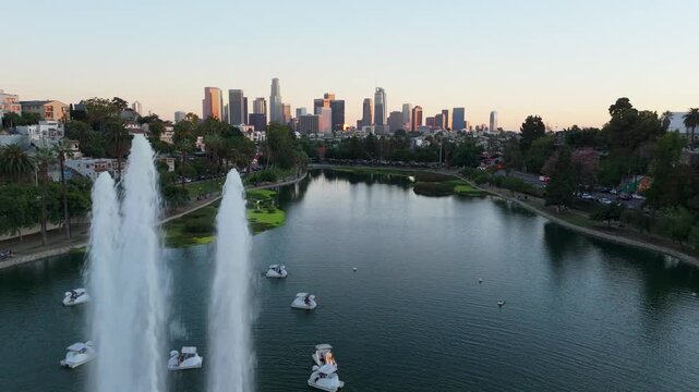 Aerial view of downtown Los Angeles skyline over Echo Park Lake at sunset