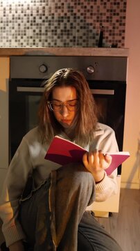 Vertical screen young woman with ADHD struggles to study distracted by phone losing concentration switching tasks constantly and unable to stay focused at home