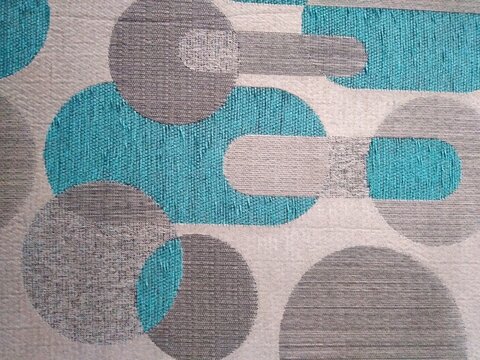 Malang, East Java, Indonesia: May 4, 2026, Photo from Mid-century inspired geometric textile featuring turquoise and gray circular and rounded rectangle shapes on textured fabric, ideal for background