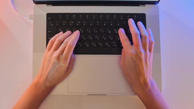 female hands typing on laptop keyboard top view on desk, entering text and working online, office workflow, digital communication, remote work routine, productivity and modern technology use