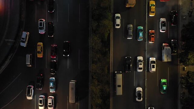 Overhead drone shot of traffic driving through streets of Guangzhou at night
