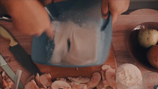 a man cuts the dough with a knife to make a homemade apple pie and
