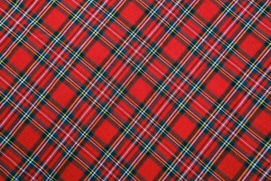 Plaid diagonal pattern, red, green, black, yellow, white, seamless for textiles and design clothing, skirts, pants, aprons, tablecloths, blankets or decorative fabrics. Vector illustration.