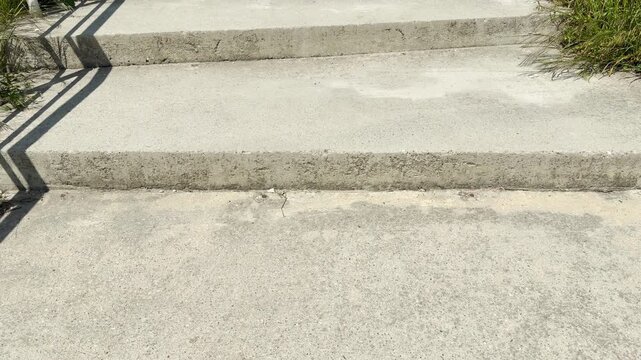 A close-up view shows a few stone steps leading upward on a sunny day. Stepping up this steady, solid path brings a comforting feeling of progress and quiet simplicity.