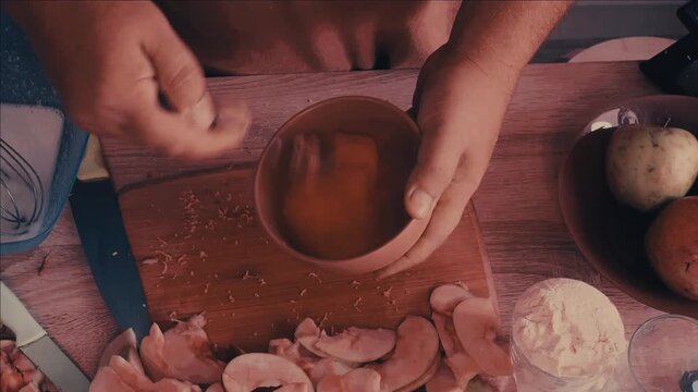 a man cuts the dough with a knife to make a homemade apple pie and