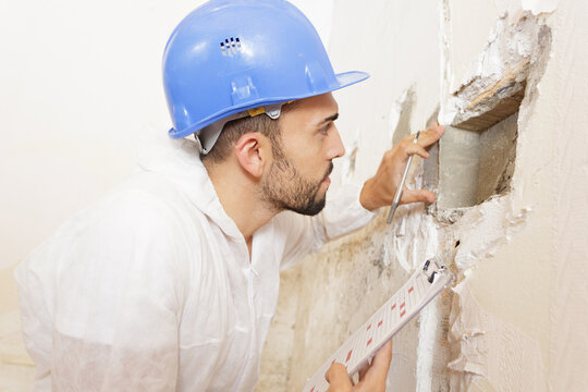 man and wall problem inspection