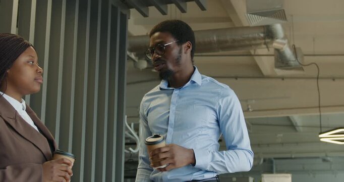 Man and woman engaging in conversation in workspace environment