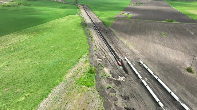 Aerial view of gas and oil pipeline construction. Pipes welded together. Big pipeline is under construction.