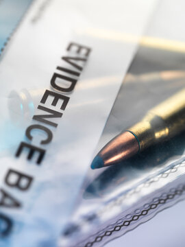 Close up of a bullet in a plastic evidence bag in a laboratory