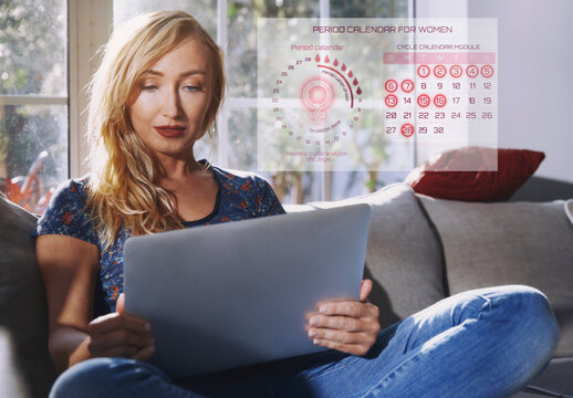 User looking at period tracker app hologram on laptop indoors