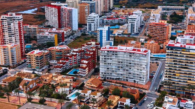 Aerial view of residential apartments near sea coast harbor. Drone shot of urban coastal architecture and multi story buildings next to a Mediterranean marina.