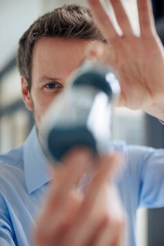 Engineer holding hourglass at workshop