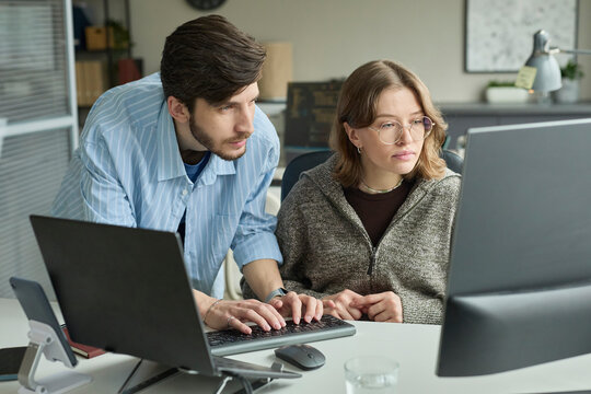 Businessman and businesswoman working on computer at the office
