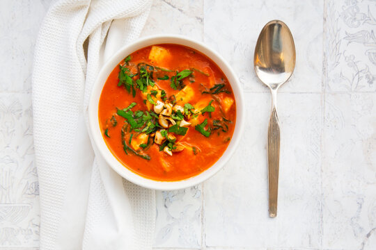 Halloumi korma curry with spinach and cashews viewed directly above