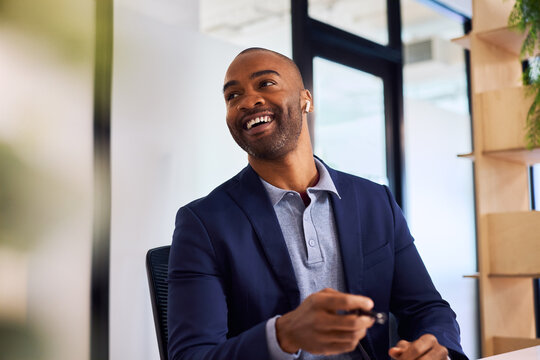 Successful black business man looking away while laughing