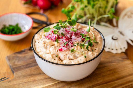 Bavarian Obatzda cheese spread with radish and cress in a bowl