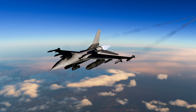 Dynamic military fighter jet flying at high speed above clouds