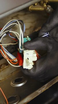 Electrician take apart burned oven switch close-up