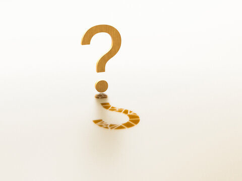 Wooden question mark with pixelated shadow on white background