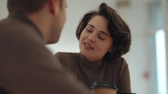 Young Woman Engaged in Friendly Conversation During a Business Coffee Break