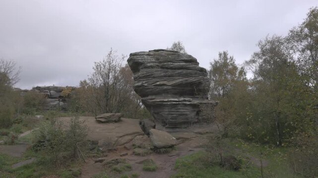 panning shot of abstract rocks in the middle of woodland in Yorkshire
