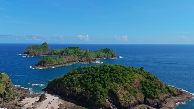 Breathtaking drone footage of tropical rocky islands surrounded by deep sea in bedil island, Banyuwangi