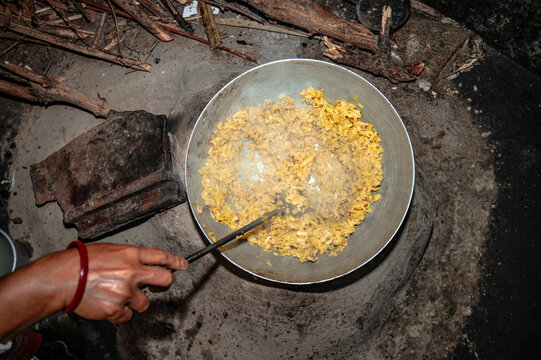 The banana stem, also known as Thor, is the fibrous, edible innermost core of the banana plant stem. An elderly woman chops a banana stem and seasons it with salt, then cooks it.