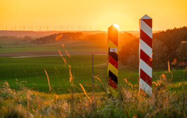 Fototapeta premium Border posts along the Polish-German border, which runs through ecologically significant green fields