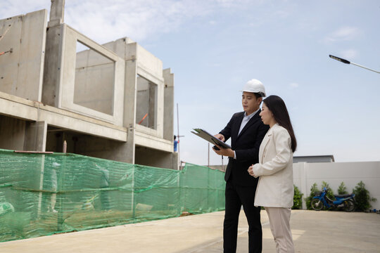 A construction project manager showing clients the project developments and future plans for the construction