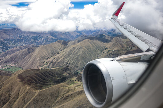 Cusco, Peru - 25 Nov 2025:  A view of the Peruvian Andes mountains from a plane window