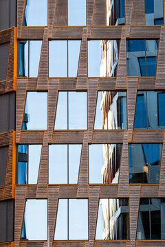 Urban reflections sharpen the texture of this modern building where architecture facade windows and glass grid create an abstract surface